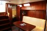 Салон внутри с мягким диваном и столом на яхте Флавия - Yachts.ua