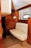 Белый кожаный диван при входе в кормовую каюту яхты Princess V42 - Yachts.ua