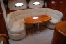 Салон с мягким кожаным диваном и столом на яхте Princess V42 - Yachts.ua