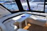 Белый кожаный диван со столом на верхней палубе яхты Princess V42 - Yachts.ua